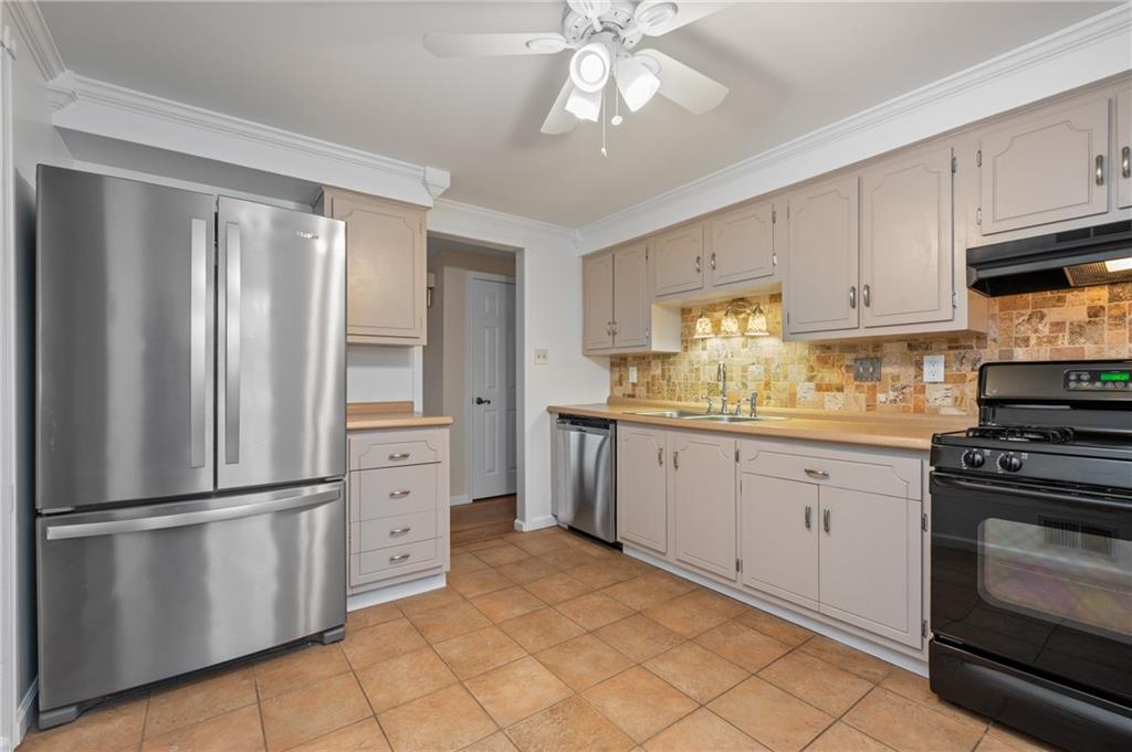 7 Dover Road Irwin, PA 15642 - Photo 10 of 31 a kitchen with white cabinets and stainless steel appliances