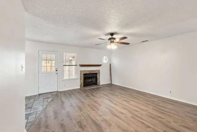wooden floor in an empty room with a fireplace