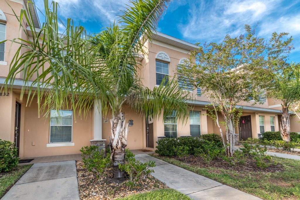 9830 Trumpet Vine Loop Trinity, FL 34655 - Photo 1 of 1 a front view of house and yard with green space