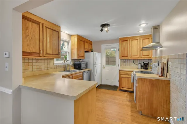 a kitchen with granite countertop a sink stainless steel appliances and cabinets