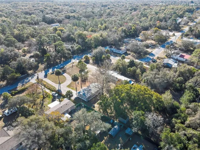 an aerial view of residential houses with outdoor space