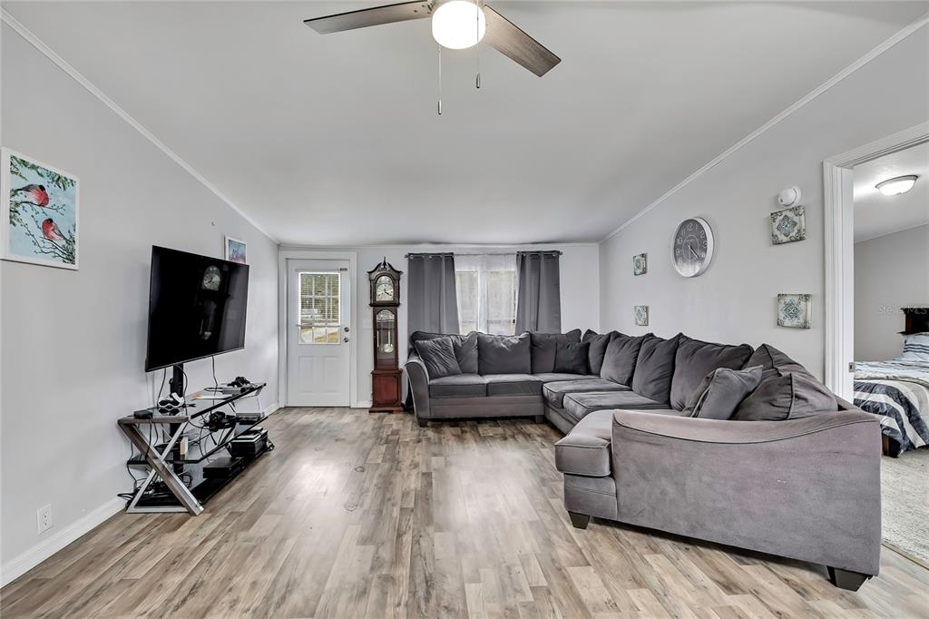 15739 Brenda Street Hudson, FL 34667 - Photo 7 of 50 a living room with furniture flat screen tv and a wooden floor