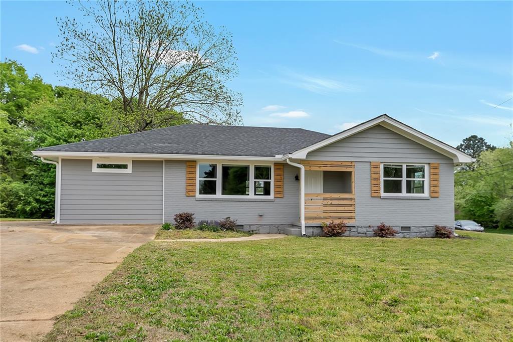 1416 Columbia Drive Decatur, GA 30032 - Photo 1 of 1 a front view of house with yard and trees in the background