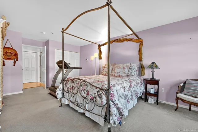 a bed room with a bed and a chair