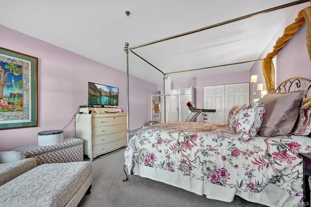 a bedroom with a large bed and a couch