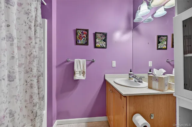 a bathroom with a sink vanity and a mirror