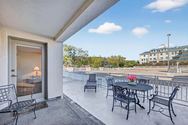 a view of a dining room with furniture and a floor to ceiling window