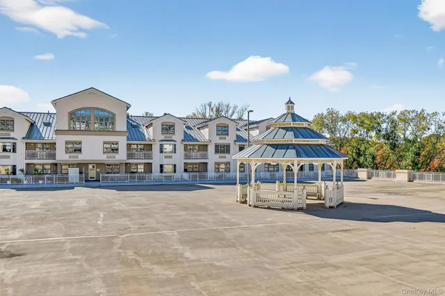 a view of a house with yard and sitting area