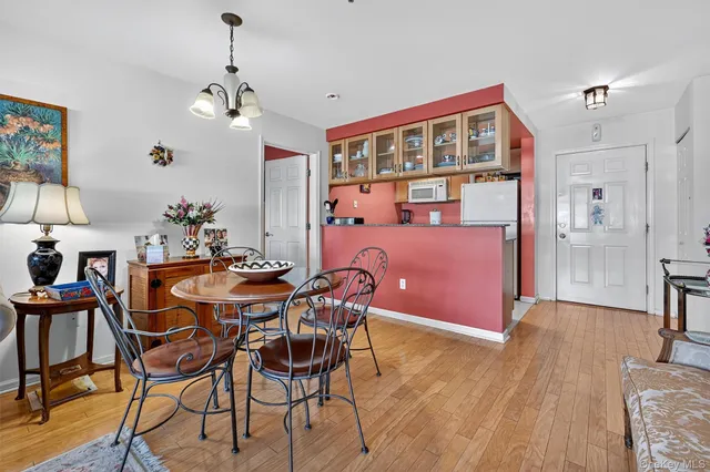 a view of a dining room with furniture and chandelier