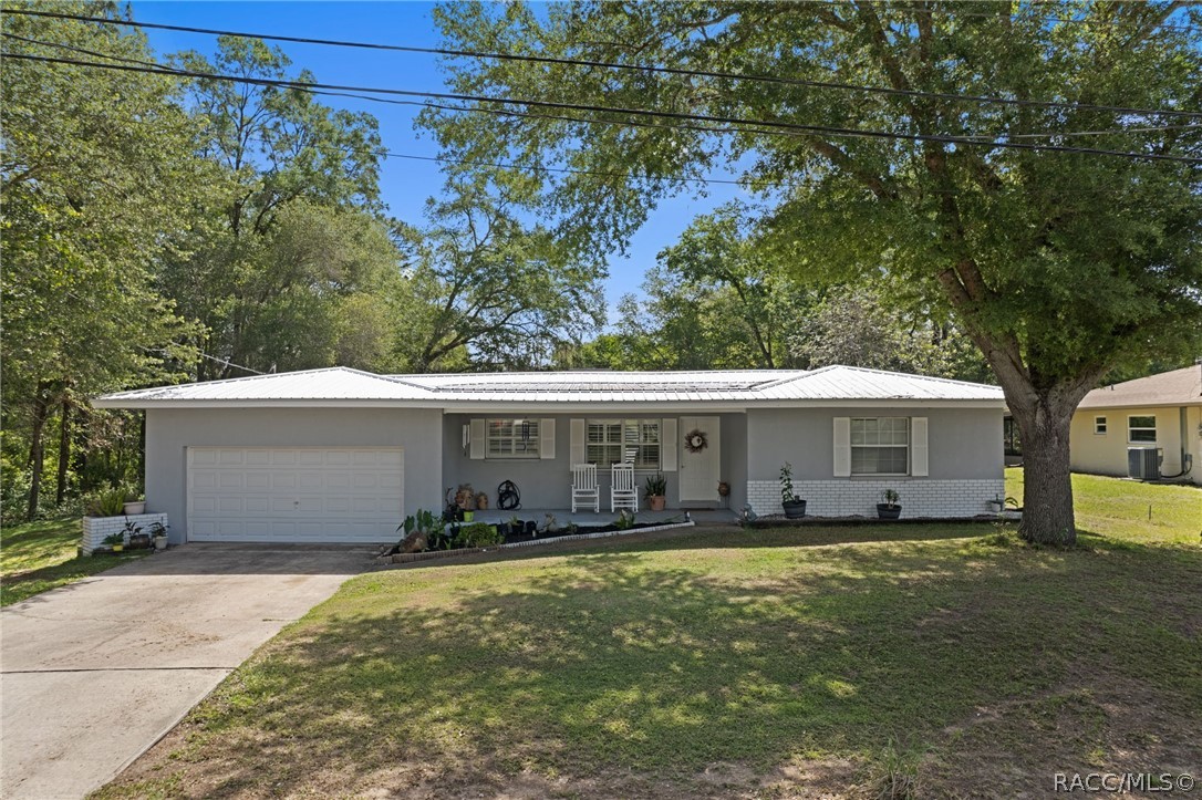 1140 South Highlands Avenue Inverness, FL 34452 - Photo 3 of 54 a front view of a house with a yard