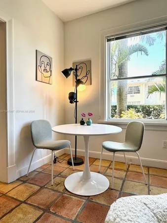 a living room with patio furniture and a window