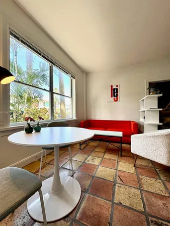 a living room with furniture a window and a table