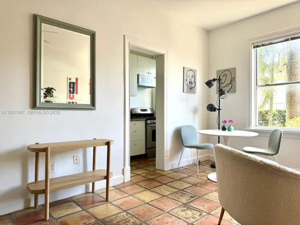 a kitchen with a sink a refrigerator and cabinets