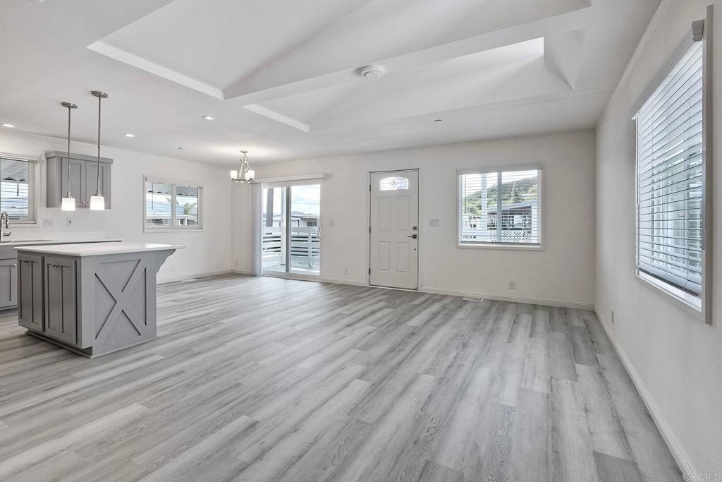 28890 Lilac Road Valley Center, CA 92082 - Photo 11 of 57 an empty room with wooden floor and windows