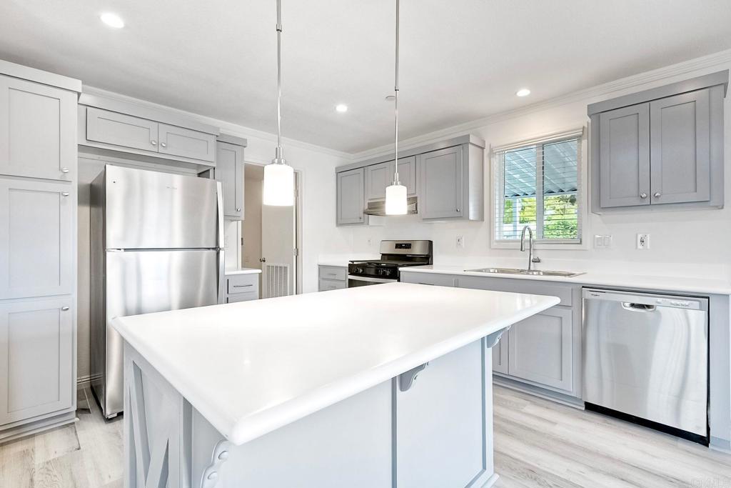 28890 Lilac Road Valley Center, CA 92082 - Photo 17 of 57 a kitchen with kitchen island a sink stainless steel appliances and window