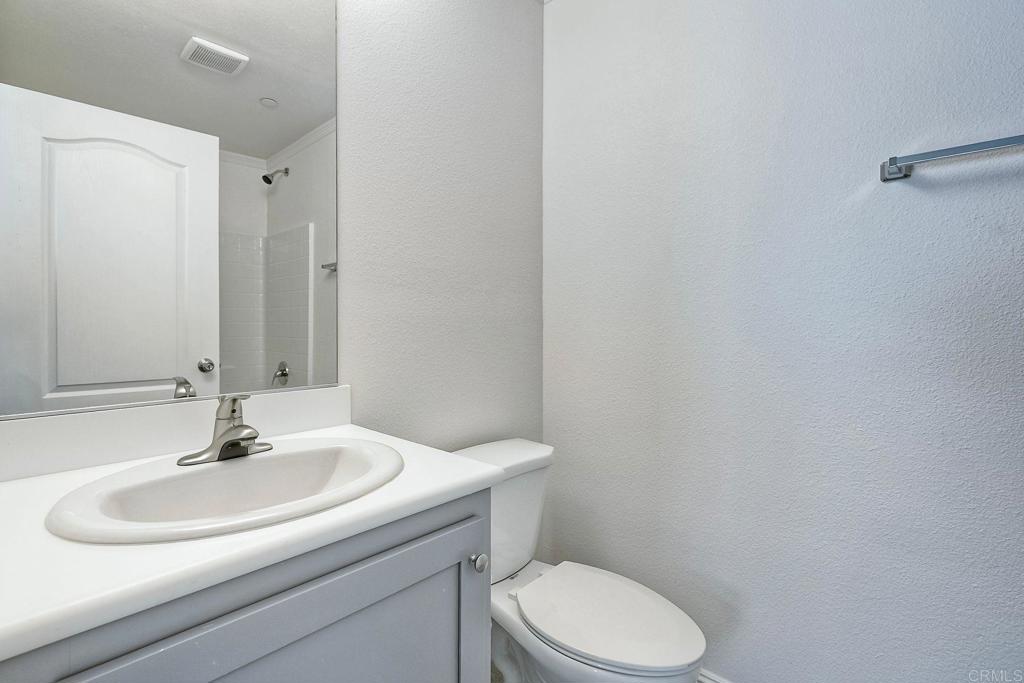 28890 Lilac Road Valley Center, CA 92082 - Photo 31 of 57 a bathroom with a sink a toilet and mirror
