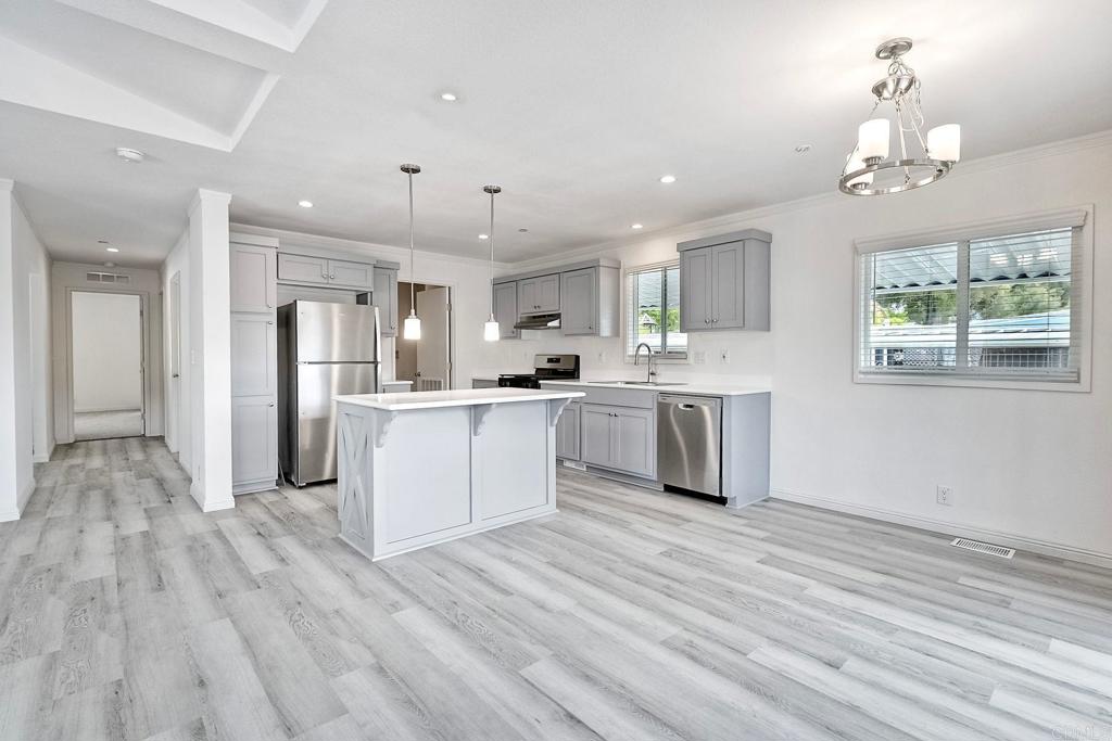 28890 Lilac Road Valley Center, CA 92082 - Photo 8 of 57 a large kitchen with kitchen island a sink stainless steel appliances and cabinets