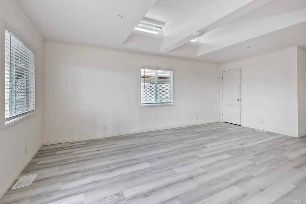 28890 Lilac Road Valley Center, CA 92082 - Photo 9 of 57 an empty room with wooden floor and windows