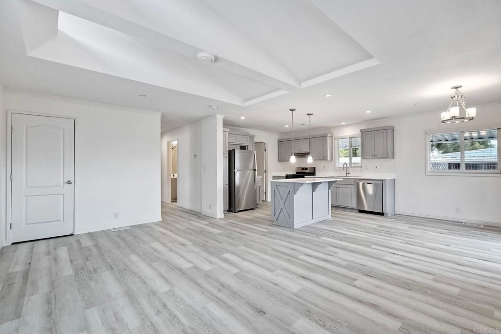 28890 Lilac Road Valley Center, CA 92082 - Photo 10 of 57 a view of a kitchen with a sink and dishwasher a refrigerator with wooden floor