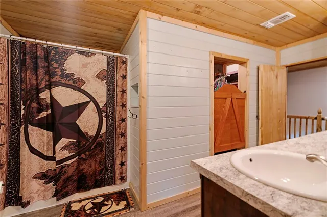 a bathroom with a sink and a shower curtain