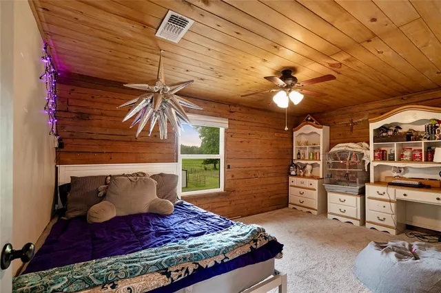 a bed room with a bed and a chair