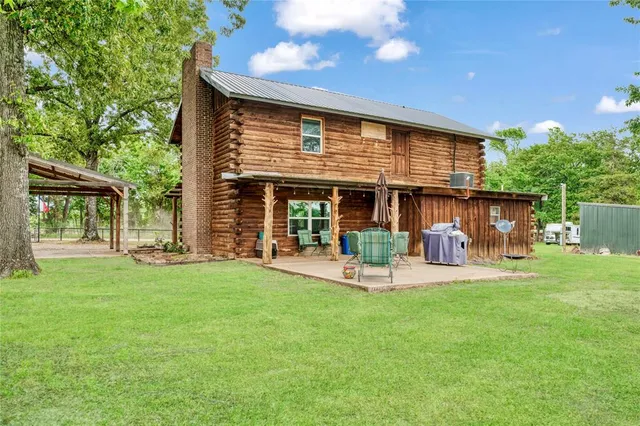 a front view of a house with a garden and patio