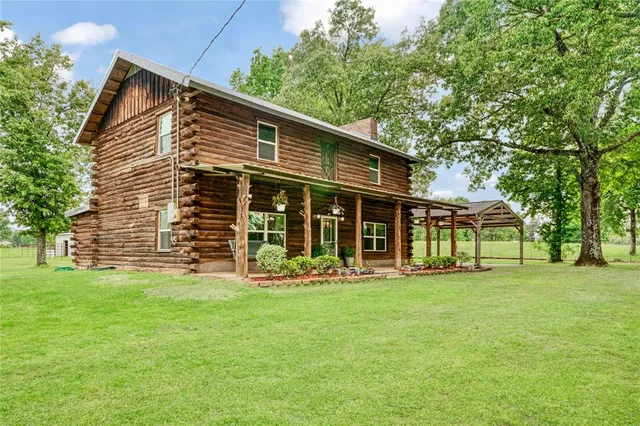 a front view of house with a garden