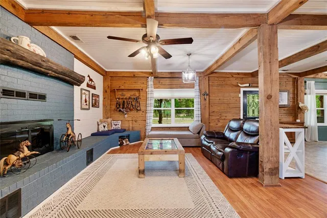 a living room with furniture fireplace and flat screen tv