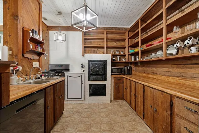 a kitchen with stainless steel appliances granite countertop a stove and cabinets