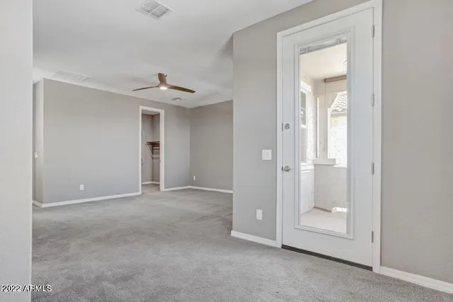 a view of a livingroom with an empty space and a window