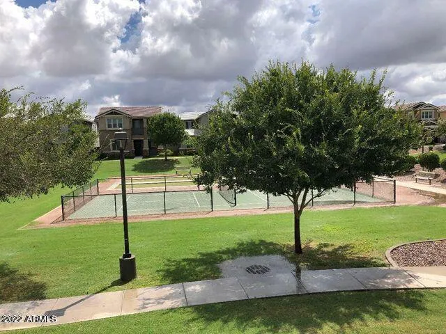 a view of a swimming pool and lounge chairs in patio
