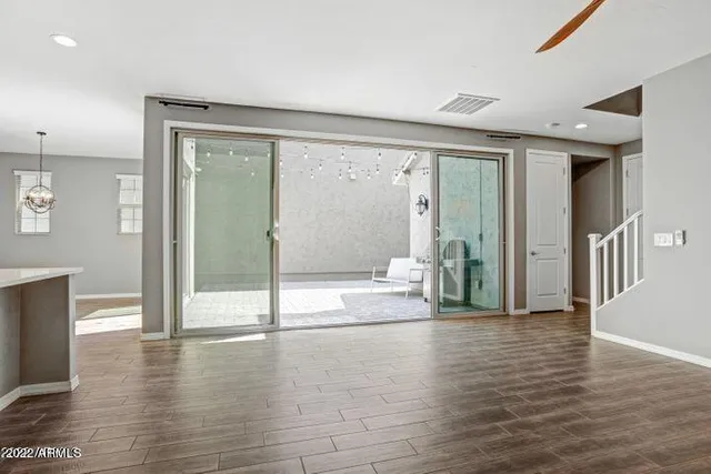 a view of a livingroom with a ceiling fan and window