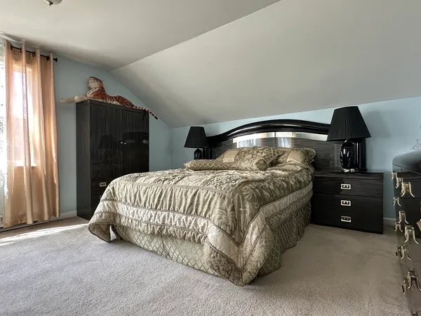 a bedroom with a bed and cabinets