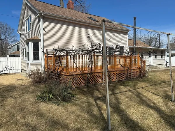a view of a house with wooden fence