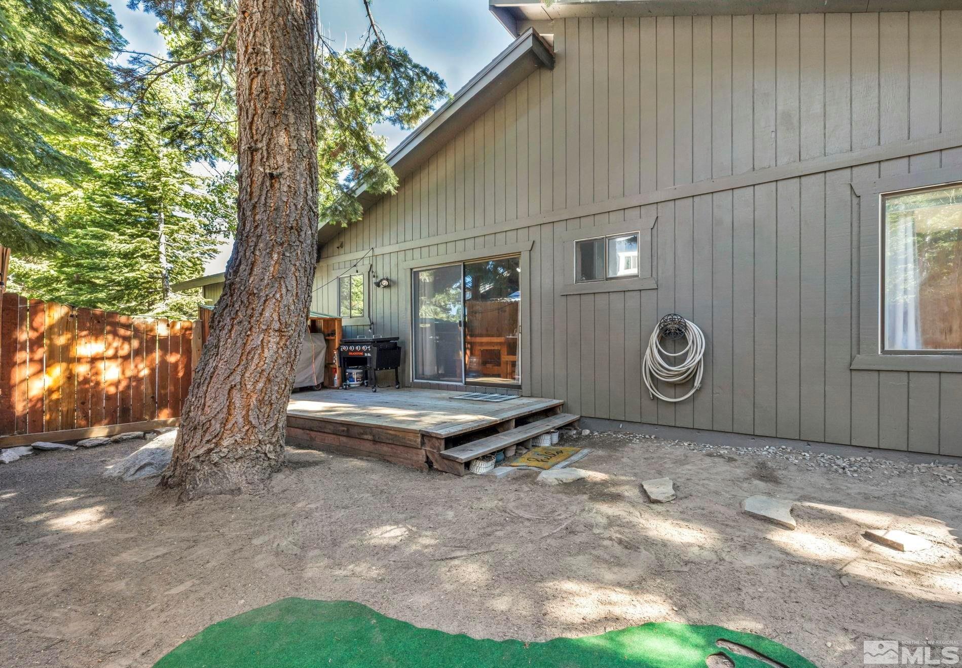 445 Andria Drive Stateline, NV 89449 - Photo 16 of 36 a backyard of a house with garden and outdoor seating