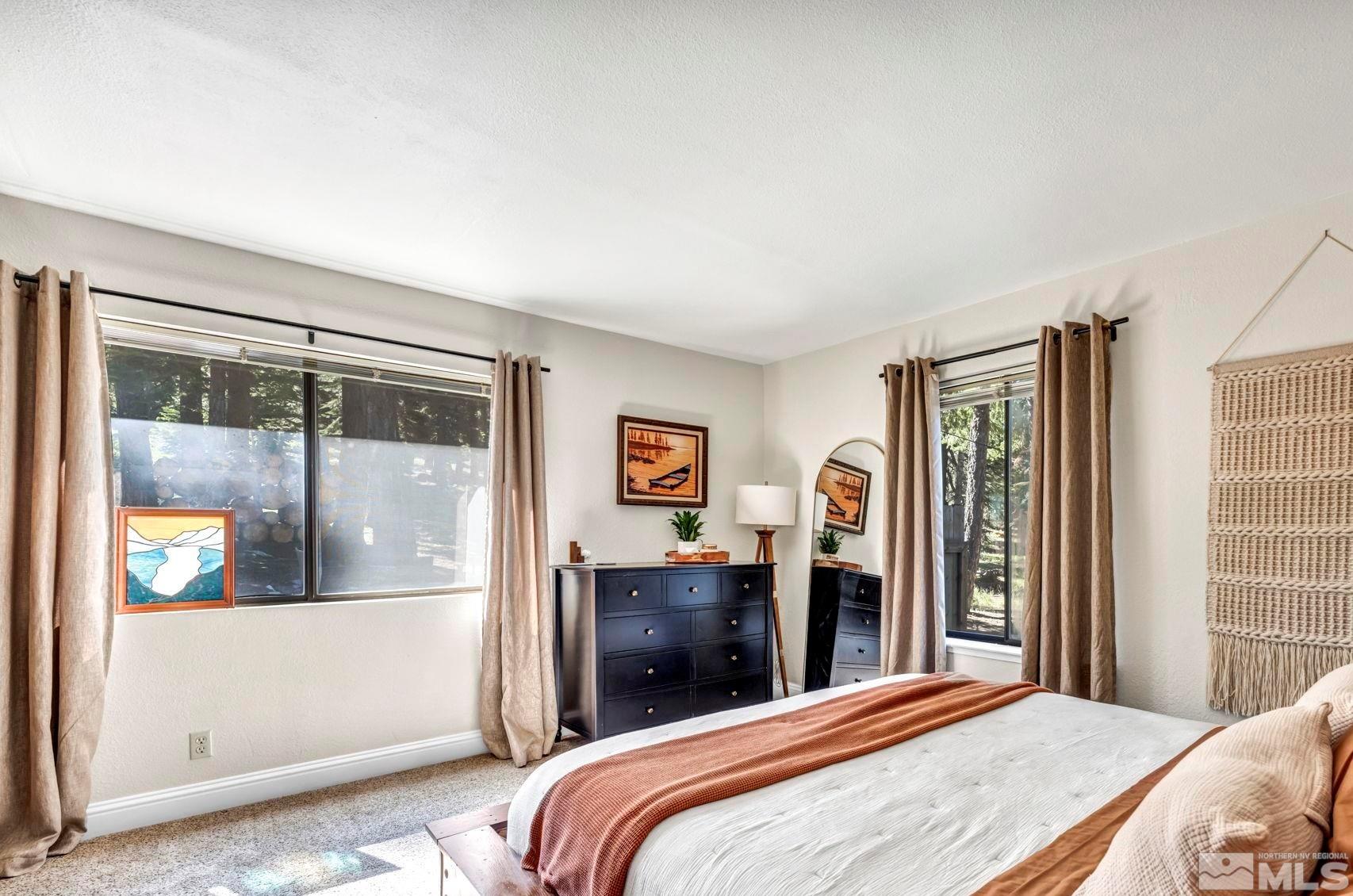 445 Andria Drive Stateline, NV 89449 - Photo 22 of 36 a bedroom with a large bed and a dresser