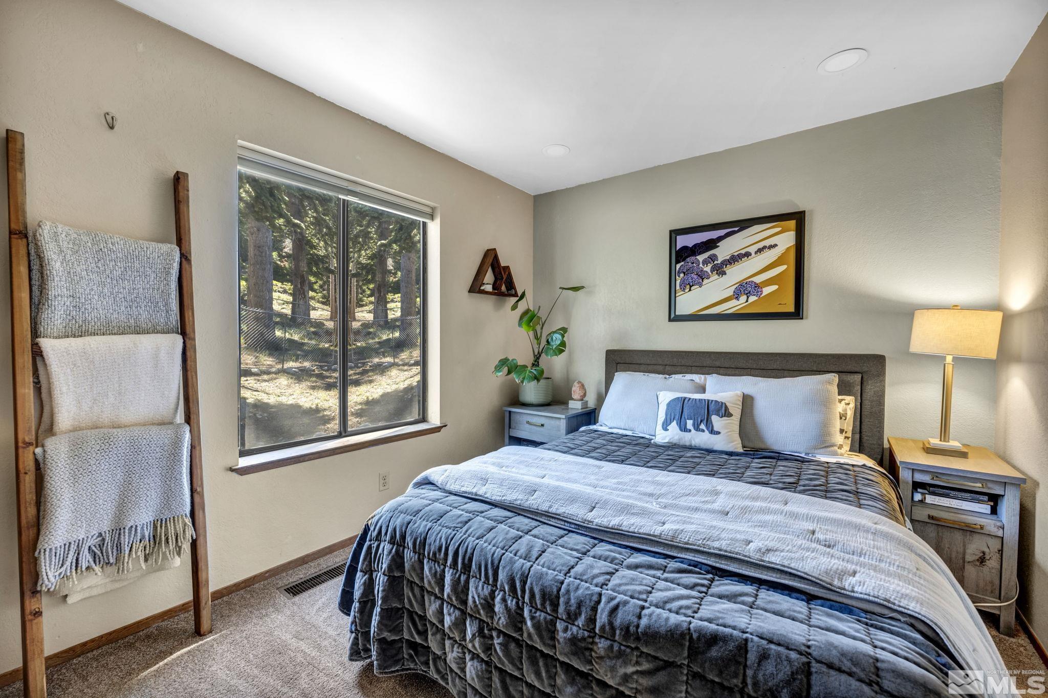 445 Andria Drive Stateline, NV 89449 - Photo 27 of 36 a bedroom with a bed and a painting on the wall