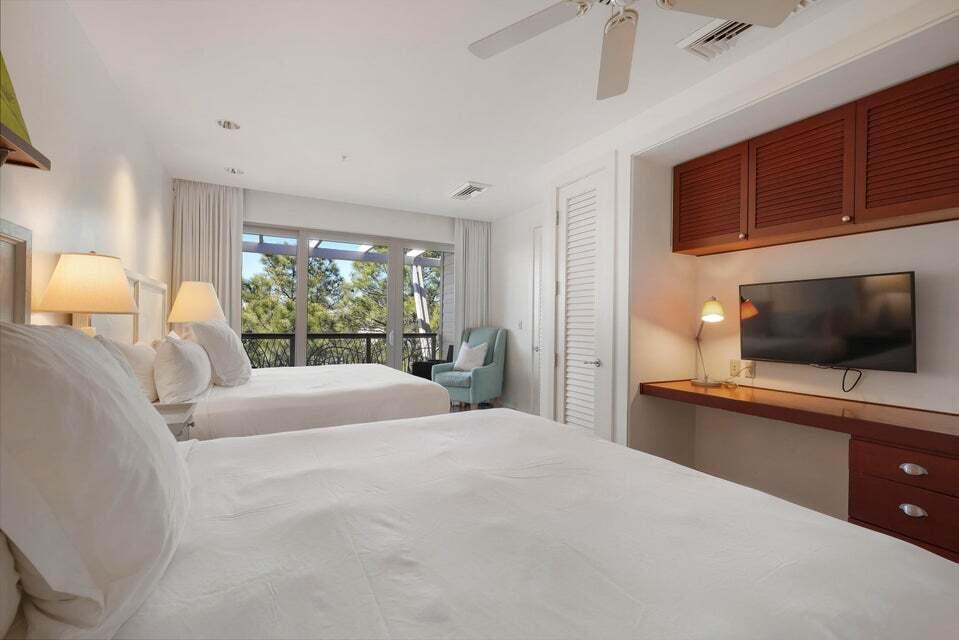 29 Goldenrod Circle, Unit 303/7 Santa Rosa Beach, FL 32459 - Photo 16 of 36 a bedroom with a bed and a flat screen tv
