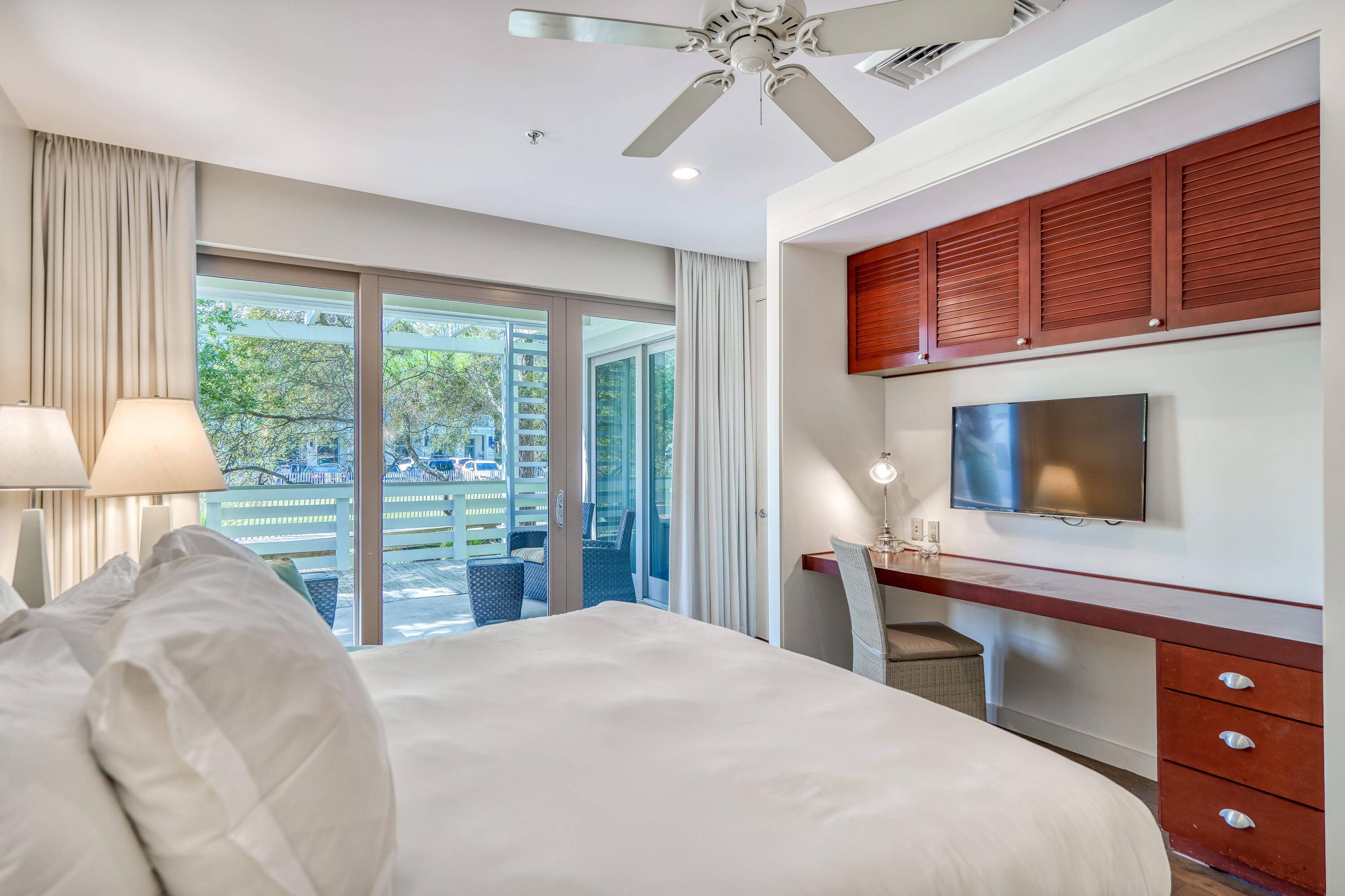 29 Goldenrod Circle, Unit 303/7 Santa Rosa Beach, FL 32459 - Photo 24 of 36 a bedroom with a bed and a flat tv screen on dresser