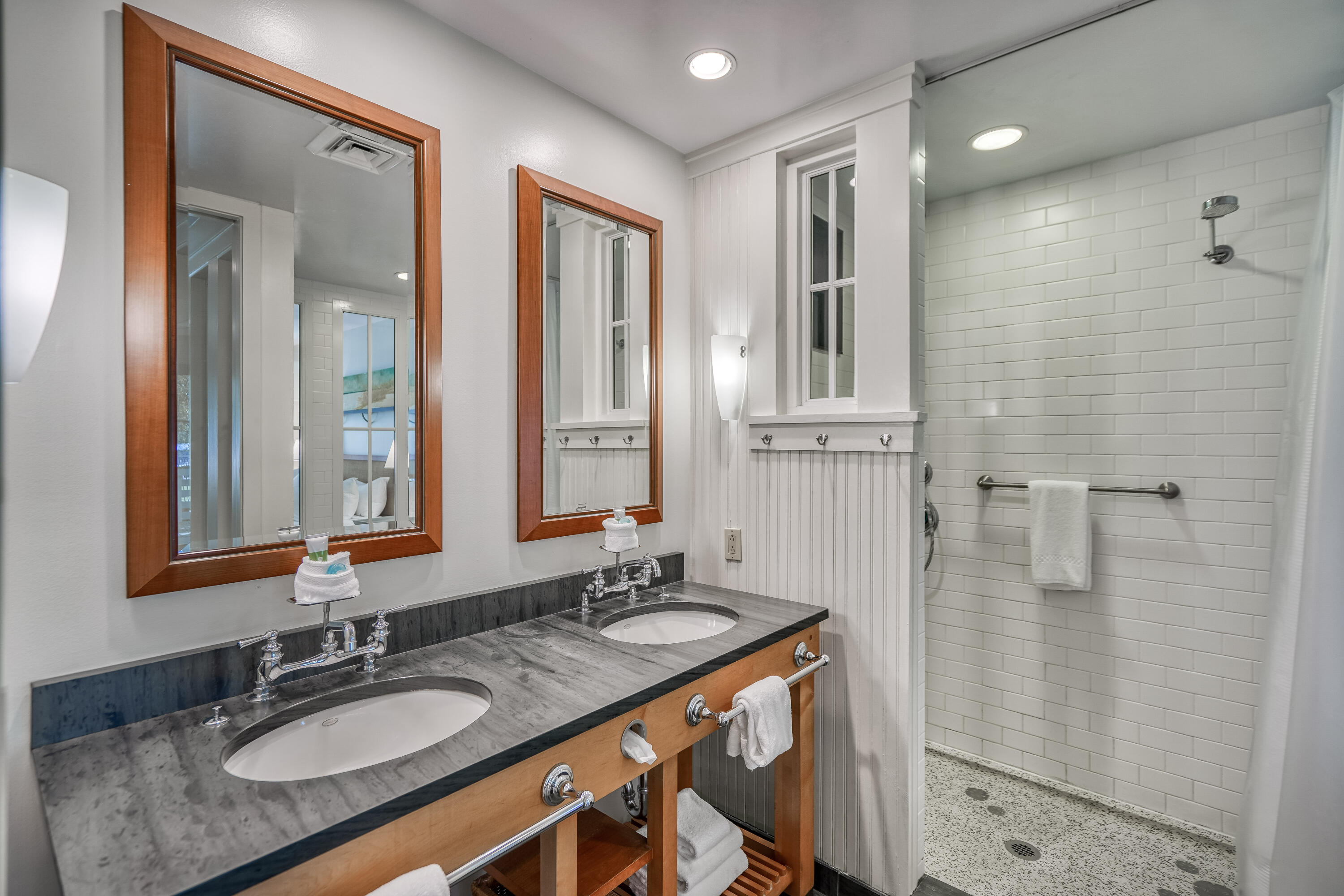 29 Goldenrod Circle, Unit 303/7 Santa Rosa Beach, FL 32459 - Photo 26 of 36 a bathroom with a granite countertop sink a mirror and shower