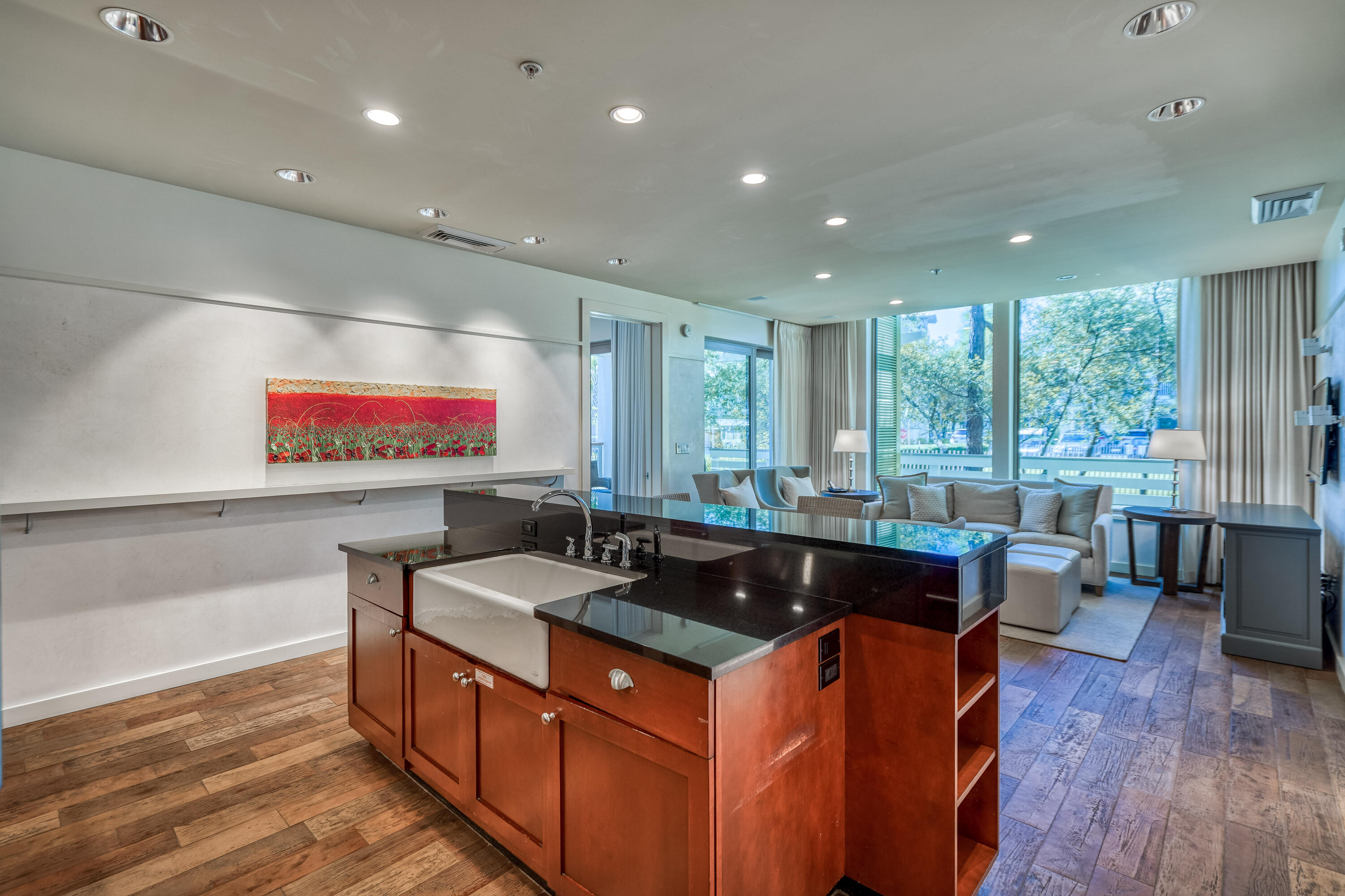 29 Goldenrod Circle, Unit 303/7 Santa Rosa Beach, FL 32459 - Photo 5 of 36 a kitchen with kitchen island granite countertop a sink and wooden floors