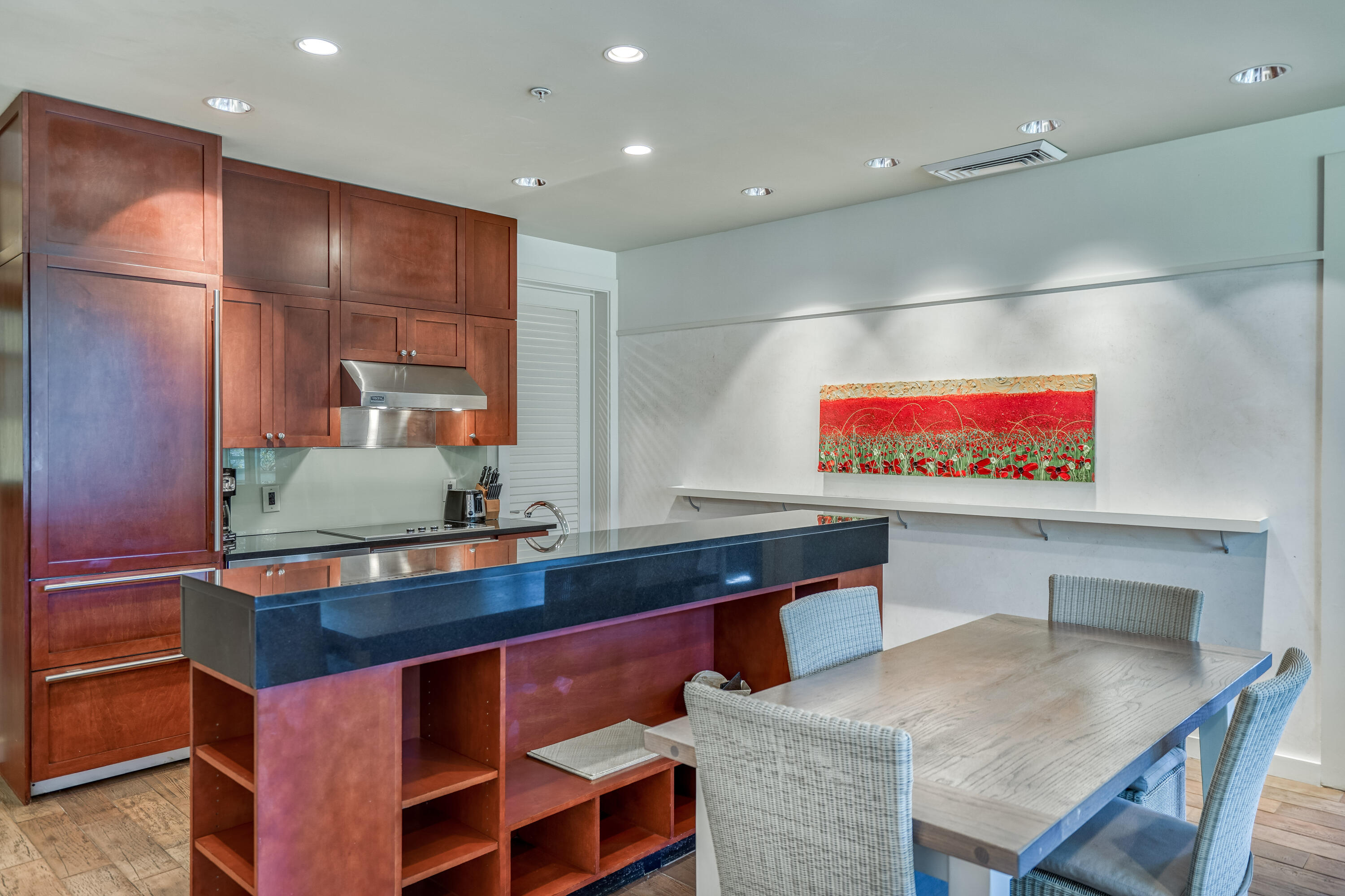 29 Goldenrod Circle, Unit 303/7 Santa Rosa Beach, FL 32459 - Photo 10 of 36 a kitchen with stainless steel appliances kitchen island granite countertop a table chairs and a refrigerator