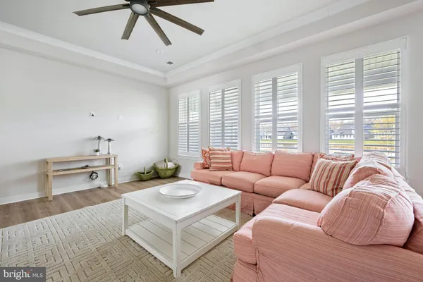 a living room with furniture and kitchen view