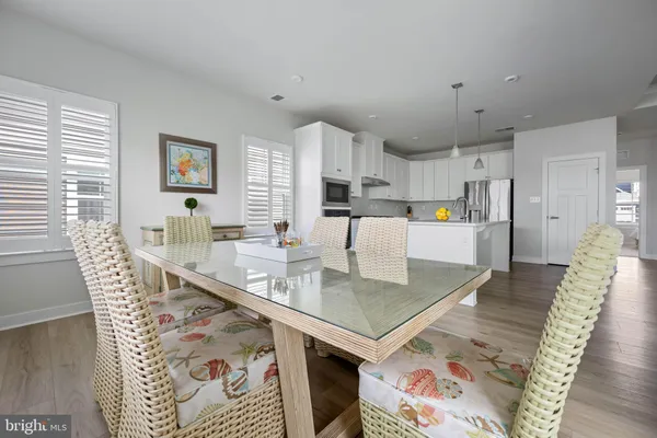 a kitchen with a sink a stove a refrigerator a center island and cabinets