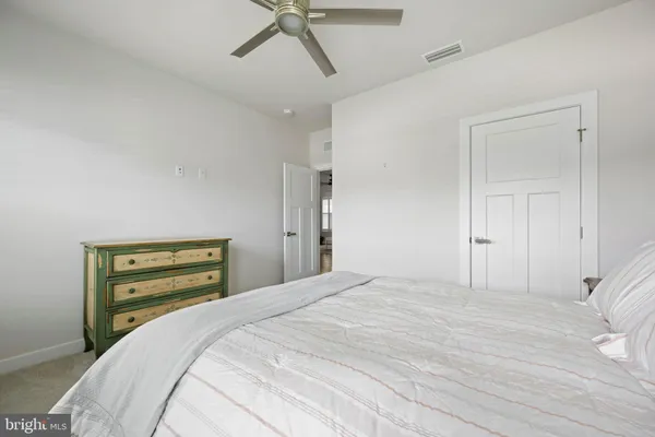 a large bed sitting in a bedroom next to a window