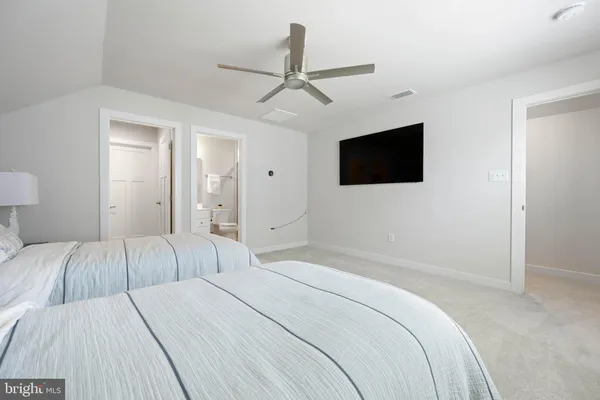 a spacious bedroom with two bed and window