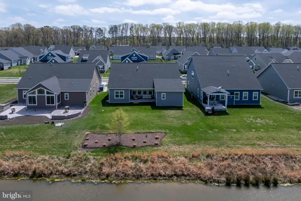 a view of a house with a big yard and large trees