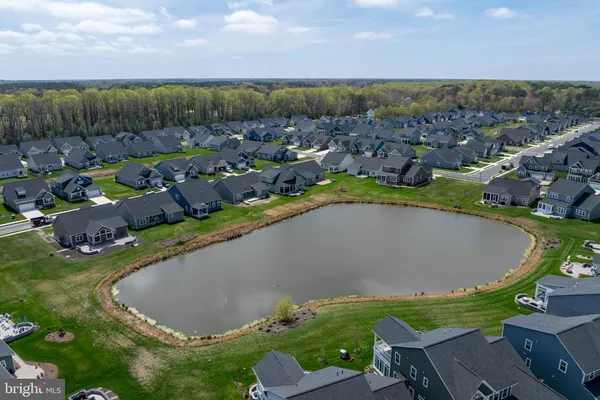 an aerial view of a house with garden space and street view