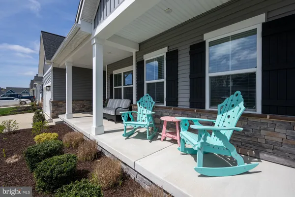 a view of a house with backyard sitting area and porch