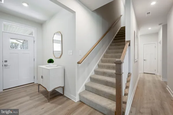a view of entryway and hall with wooden floor